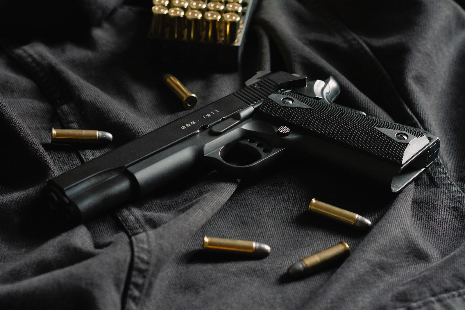 black semi automatic pistol on black textile